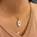 Pingente Madrepérola Olho Grego Borda Com Zircônias Folheado a Ouro 18k