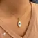 Pingente Madrepérola Olho Grego Borda Com Zircônias Folheado a Ouro 18k
