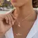 Gargantilha Golfinho Pulando Aro Cravejado de Zircônia Folheada a Ouro 18k